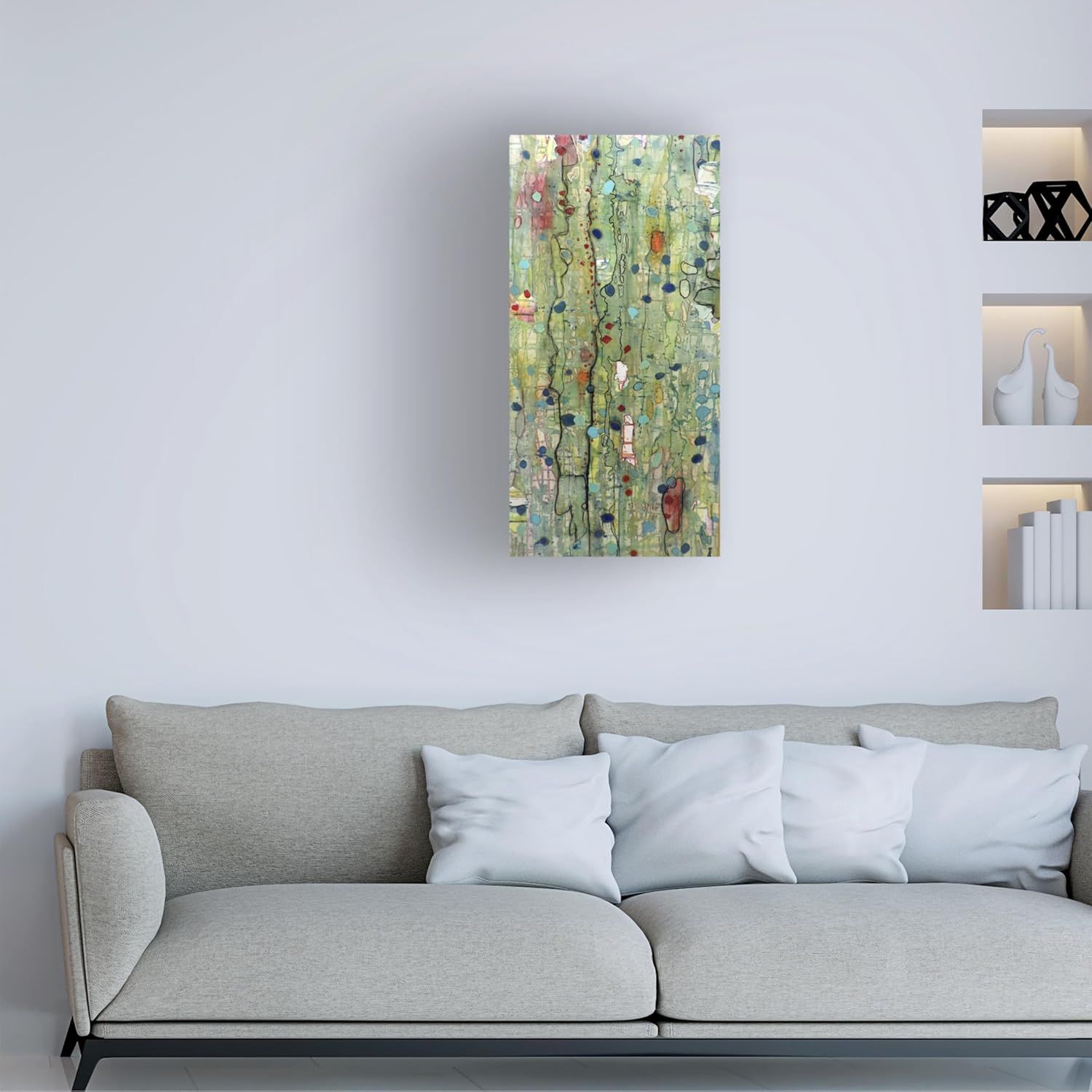 Demonstrates how the product (abstract canvas wall art) looks when displayed in a real living room setting, helping shoppers visualize it in their own home.