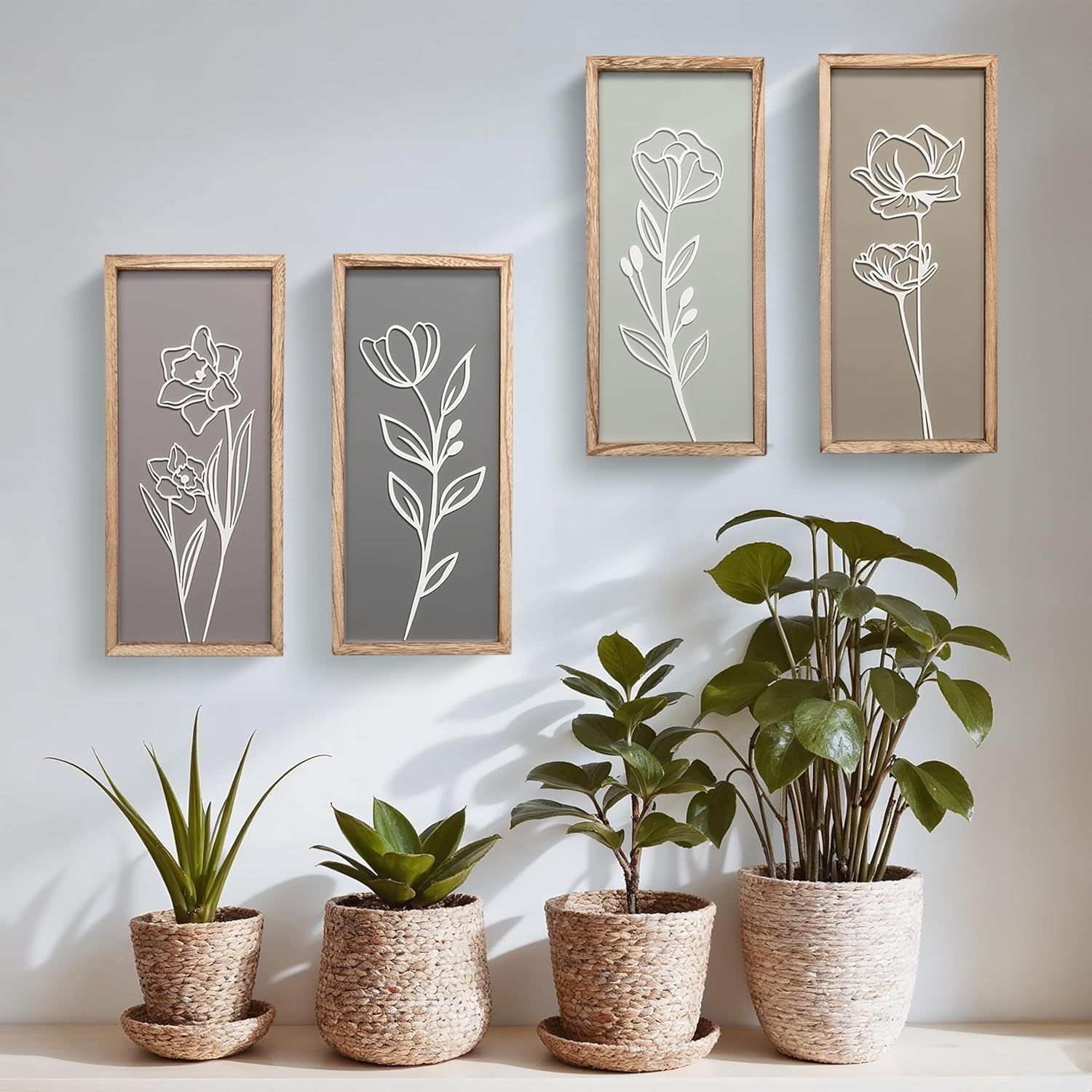 Showcases the product (decorative wall art frames) in a real-world home setting to help shoppers visualize how the product looks when styled with plants and decor.