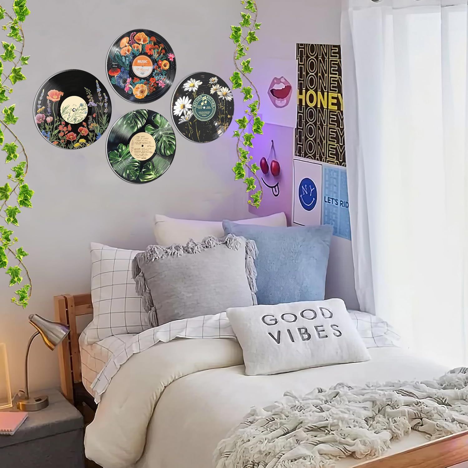 Demonstrates how the product (decorative vinyl record wall art) looks when styled in a real bedroom setting, helping shoppers visualize the product in their own space.