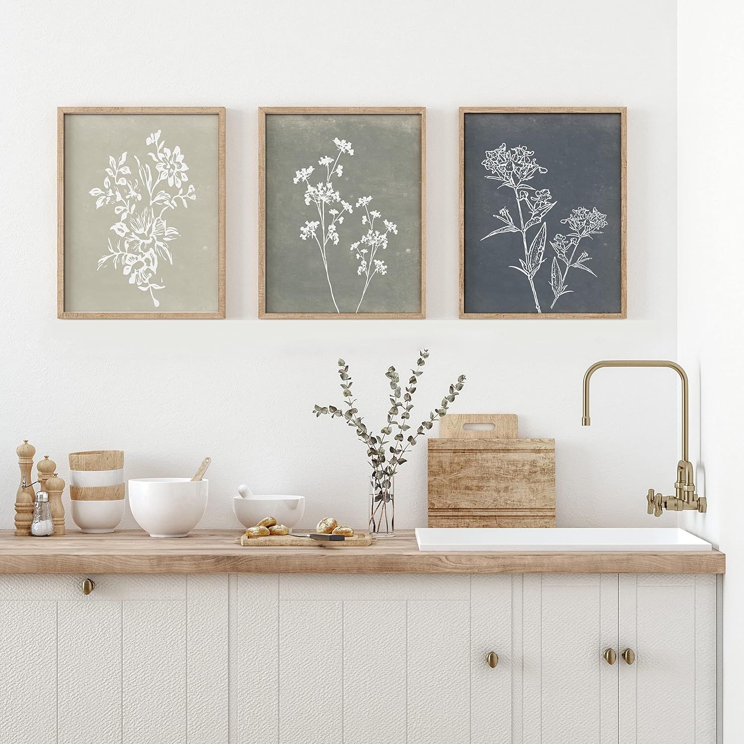 Demonstrates how the framed botanical art prints look when displayed in a real-world kitchen environment, helping shoppers visualize the product in their own home.