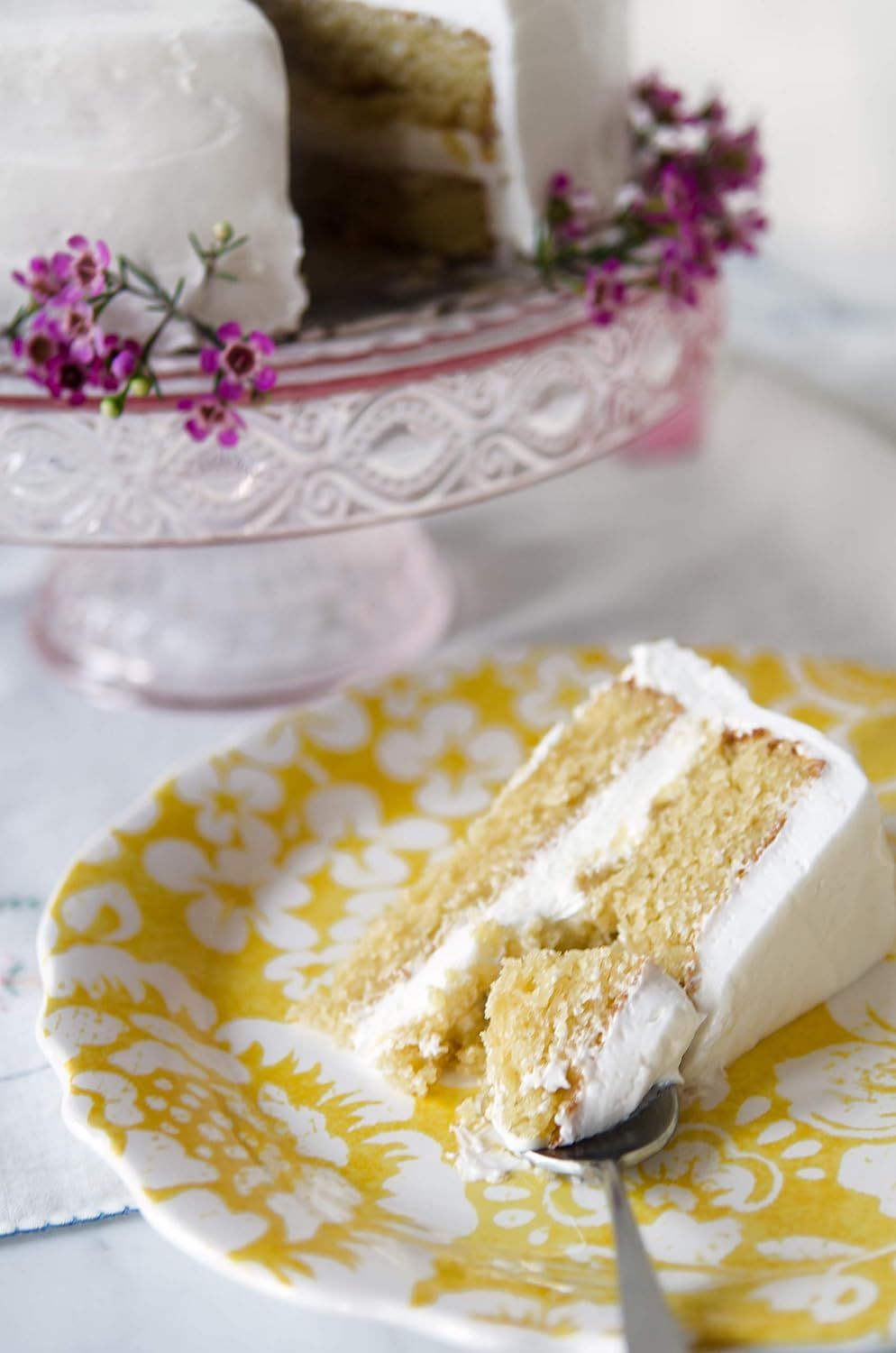 Showcases the product in a beautiful, real-world home setting to help shoppers visualize the cake as part of an elegant dining or entertaining experience.