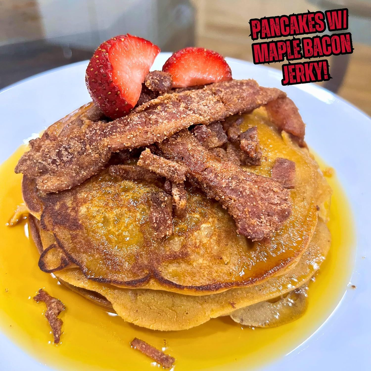 Highlights the distinctive and indulgent flavor pairing of pancakes with maple bacon jerky and strawberries to attract shoppers looking for a unique breakfast product.