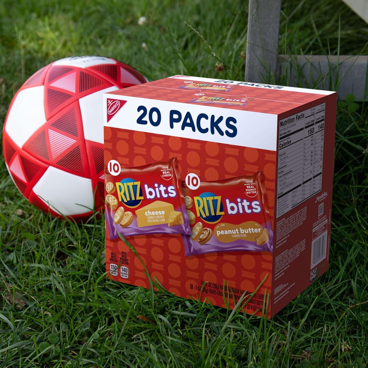 Shows the product in a real-world outdoor setting with a soccer ball to position it as a convenient snack for active lifestyles and sports activities.