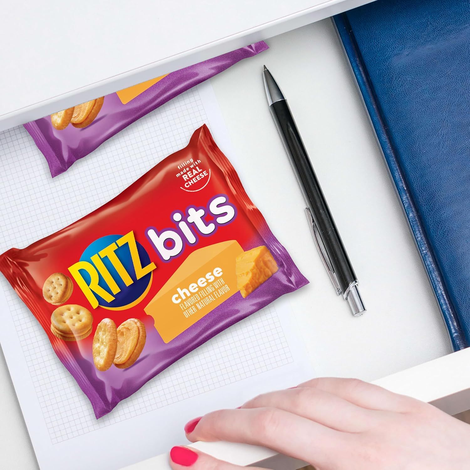 Demonstrates the product in a real-world context (desk/work/school setting) to help shoppers visualize using it as a convenient snack during daily activities.