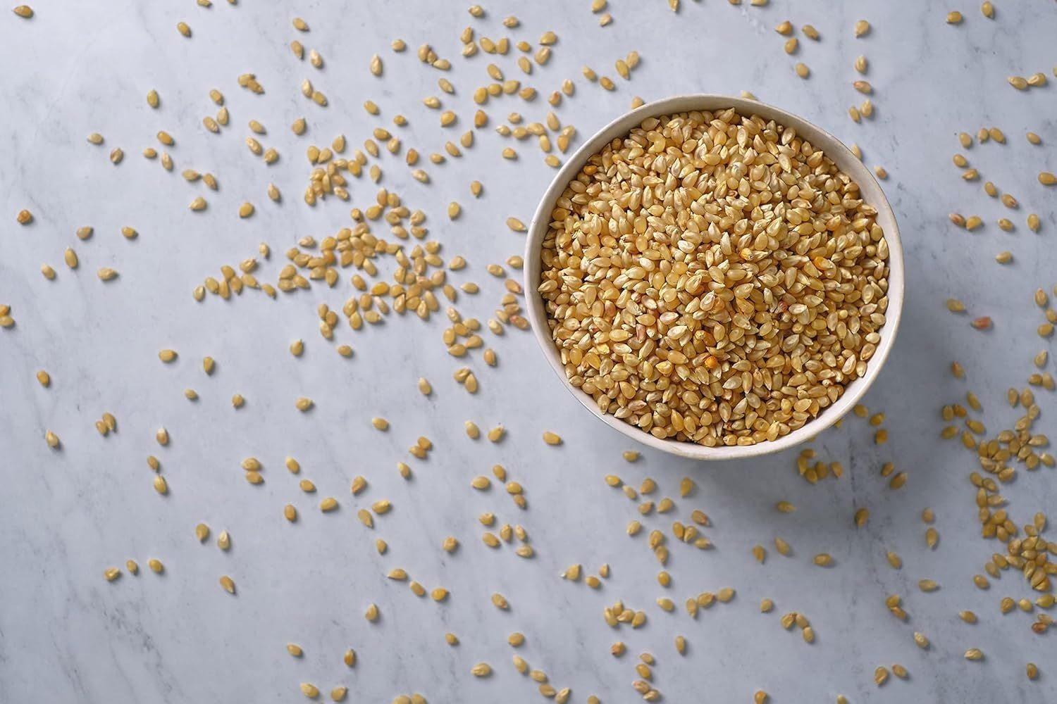 Showcases the product (grains/seeds) in an appealing, natural lifestyle context to help shoppers visualize the product's appearance and quality without any distracting text or claims.