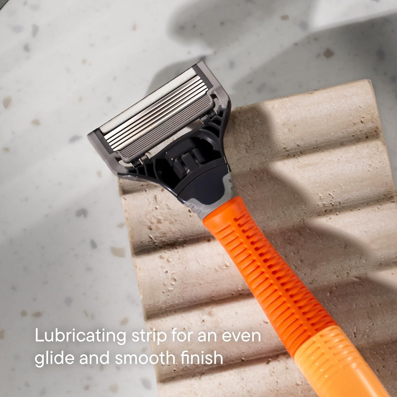 Highlights the lubricating strip feature of the razor to communicate that it provides an even glide and smooth finish during shaving. Communicates the benefit of a smooth, comfortable shaving…