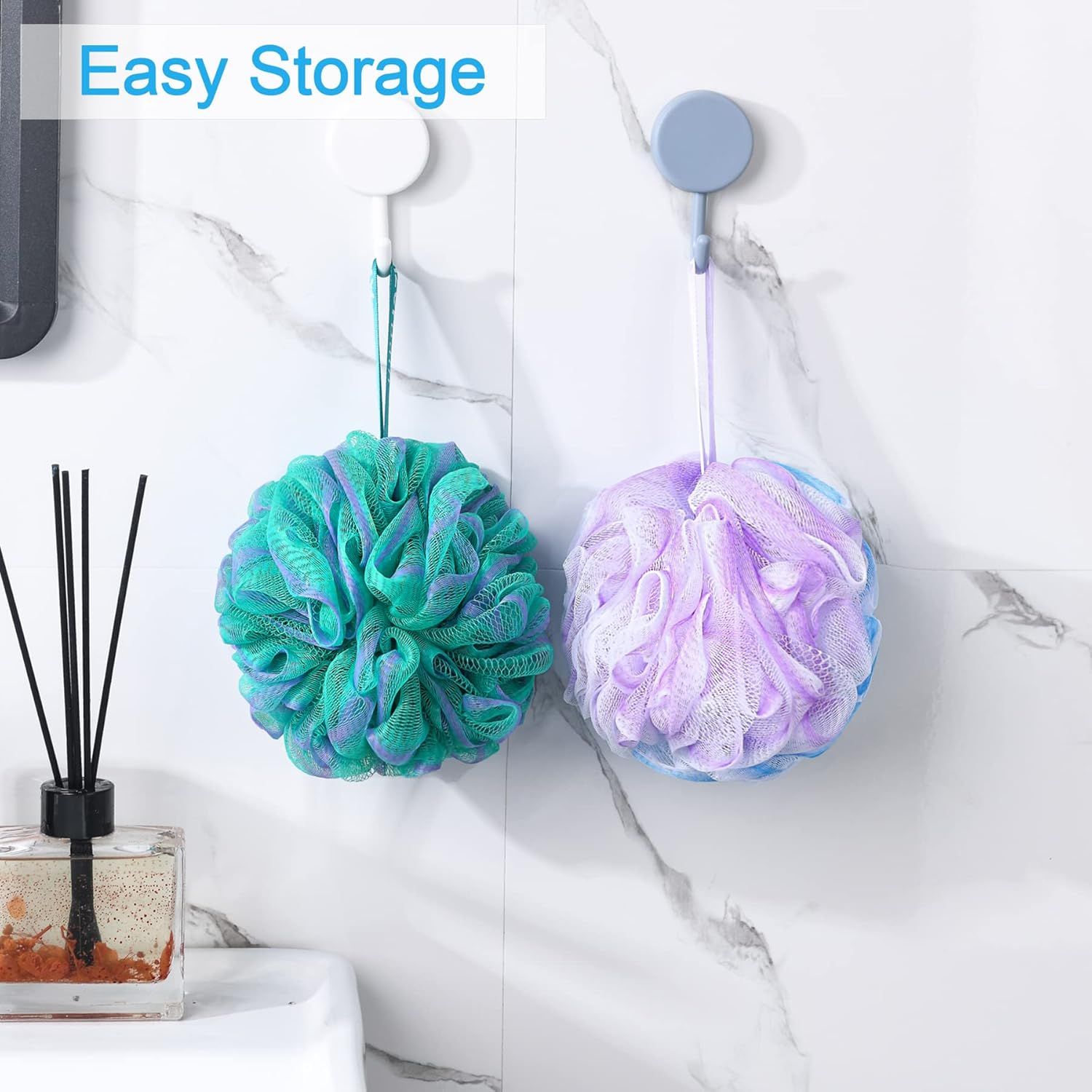 Demonstrates that the bath loofahs can be conveniently hung and stored using the attached loops, keeping the bathroom organized and allowing them to dry properly.