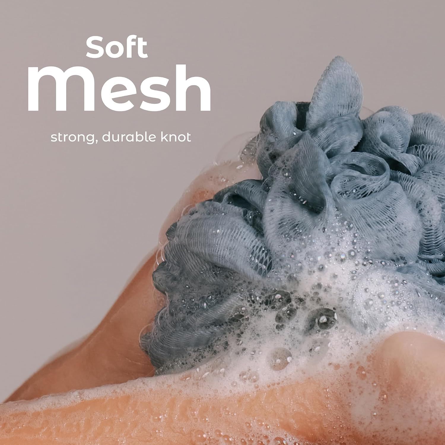 Highlights the soft mesh material and durable knot construction of the bath sponge to communicate comfort and longevity to shoppers.
