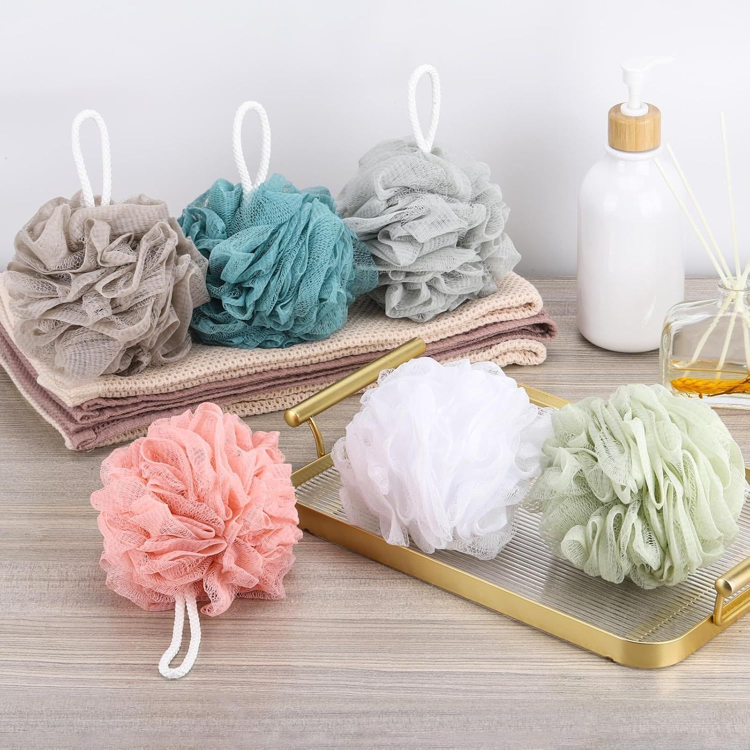 Shows everything included in the bath set purchase, displaying the variety of loofah colors, towels, and complementary bath accessories to help shoppers understand the complete value of the bundle.