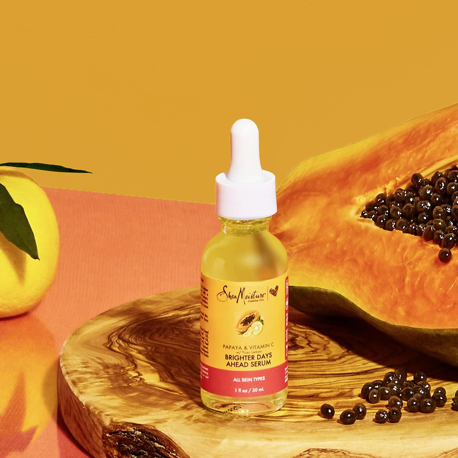 Showcases the product in a natural, visually appealing lifestyle setting with fresh papaya to reinforce the natural ingredient story and create an aspirational, organic brand aesthetic.