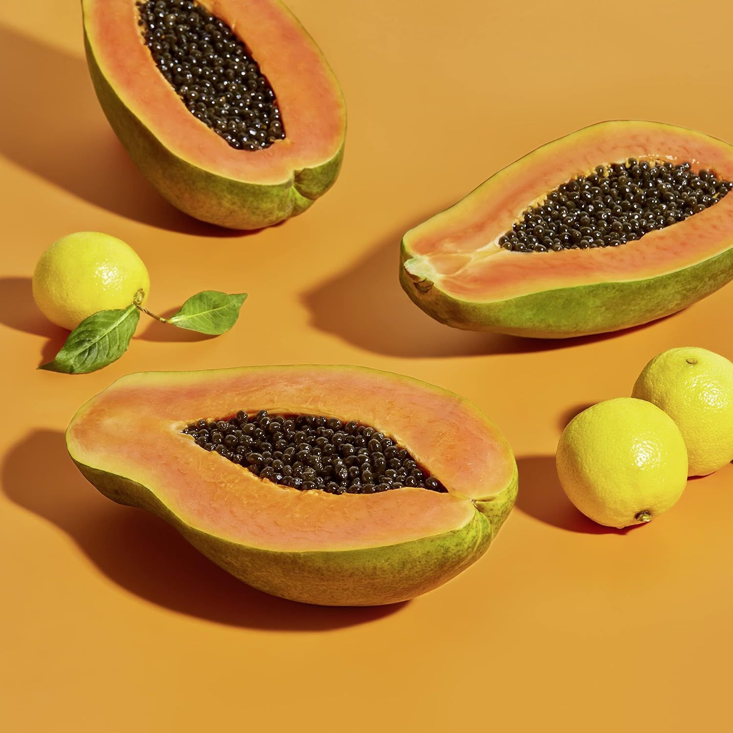 Communicates the product's natural, fresh ingredient profile through an aesthetically styled lifestyle photograph of papaya and citrus fruits, building trust and appealing to shoppers seeking…