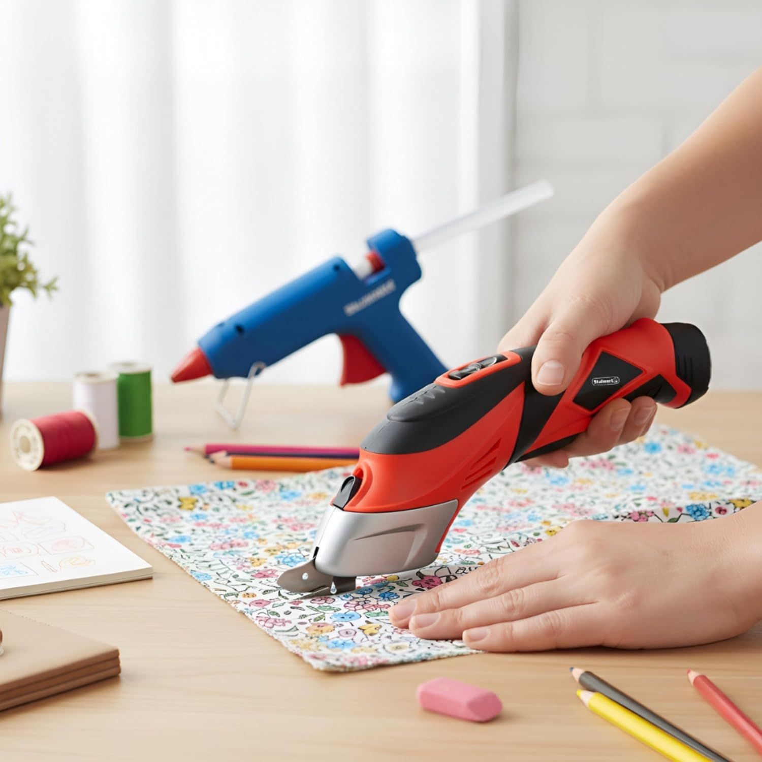Demonstrates the product in a real-world crafting environment to help shoppers visualize how they would use the cordless glue gun for DIY and fabric projects.