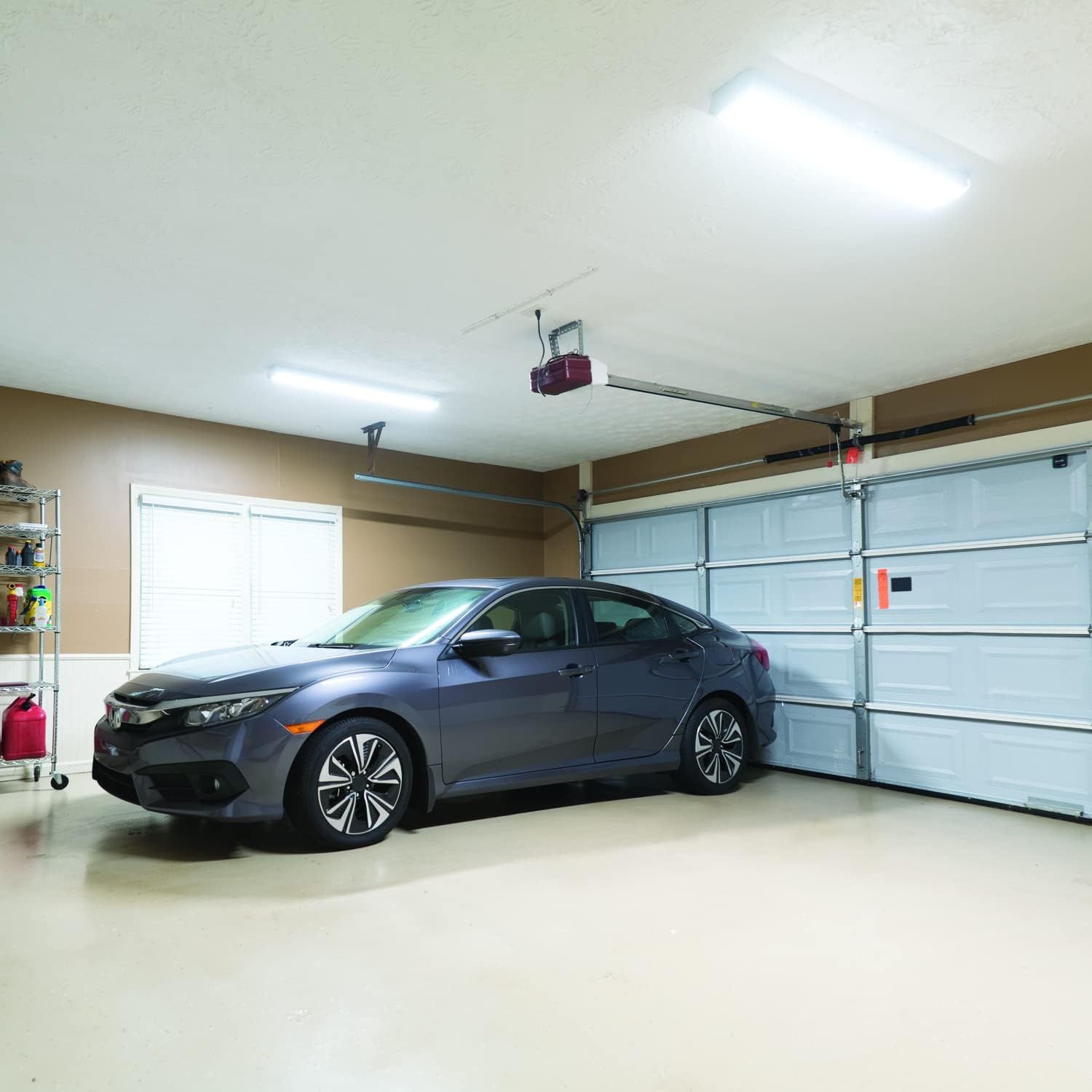 Demonstrates the product (garage door opener) in its natural environment to help shoppers visualize it installed and functioning in their own garage.