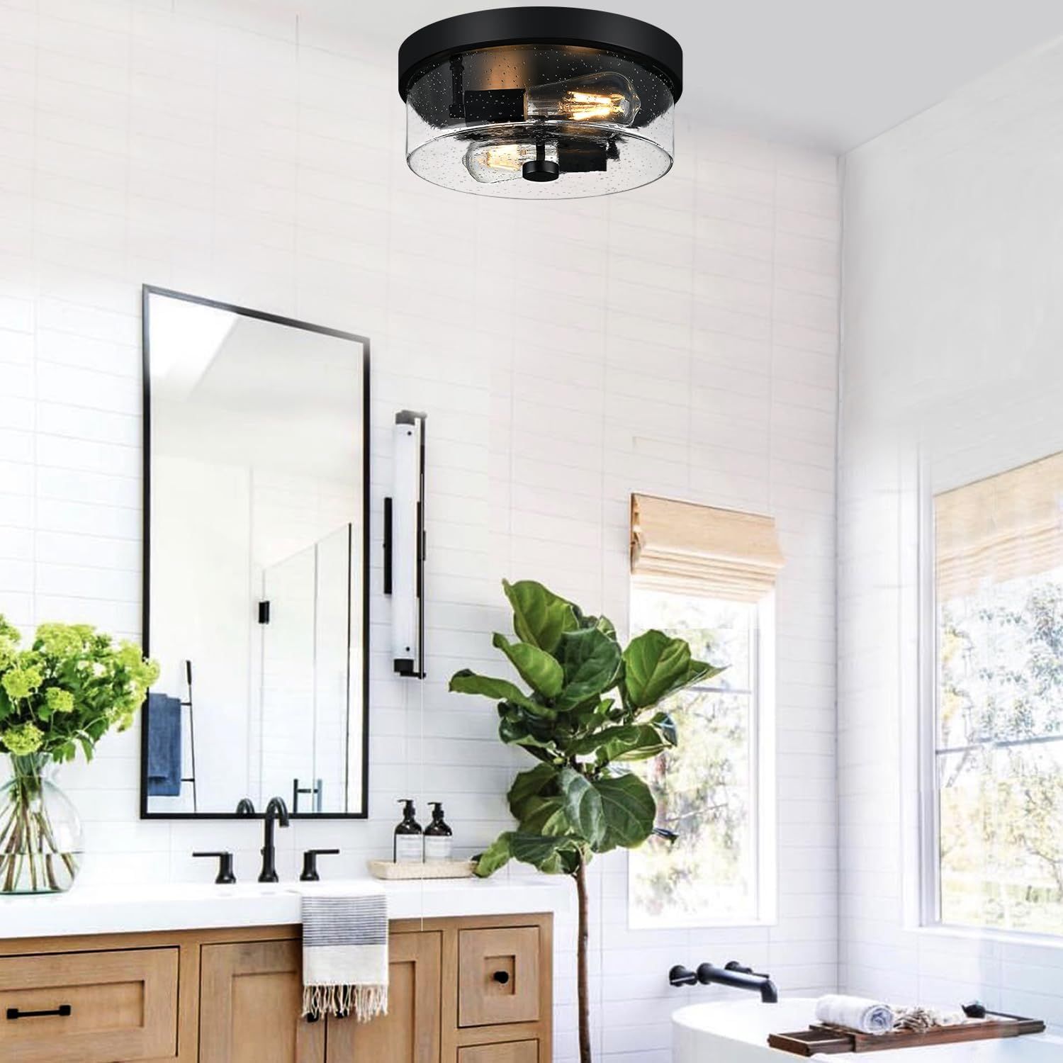 Showcases the product installed in a real-world bathroom environment to help shoppers visualize how the light fixture will look in their own home.