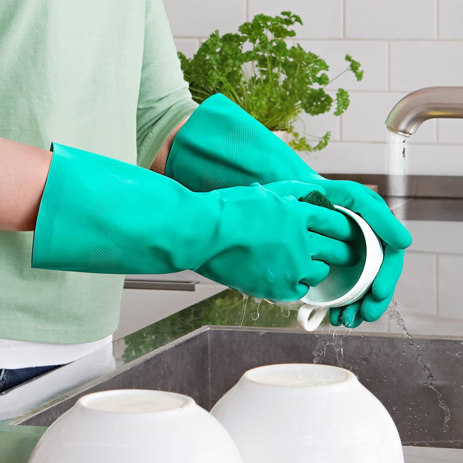 Demonstrates the product in a real-world kitchen setting, showing the gloves being used for dishwashing to help shoppers visualize practical everyday use.