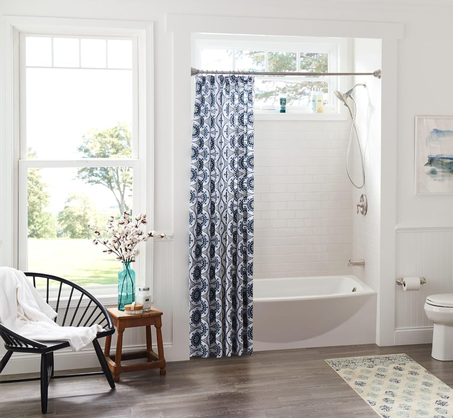 Showcases the product (shower curtain) in a real-world bathroom environment to help shoppers visualize how it looks in their own home and fits with their decor style.