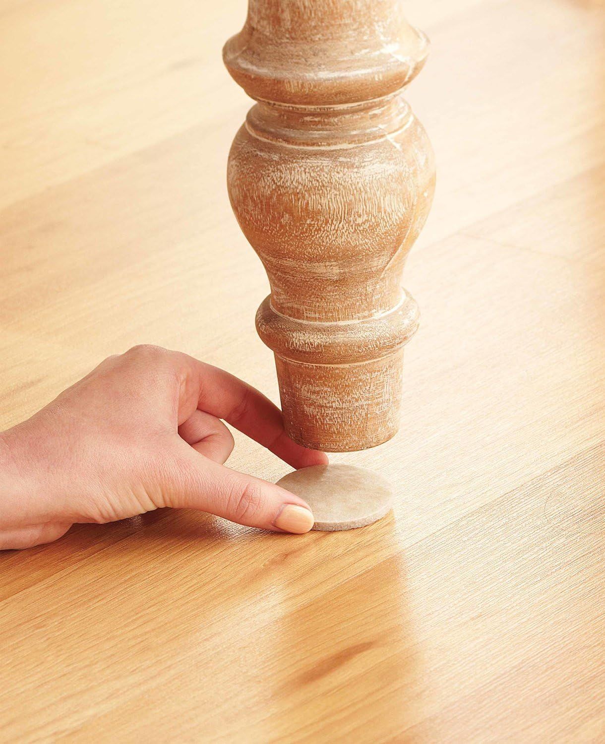 Demonstrates that the product includes protective felt pads to prevent furniture from scratching floors and to keep items stable.