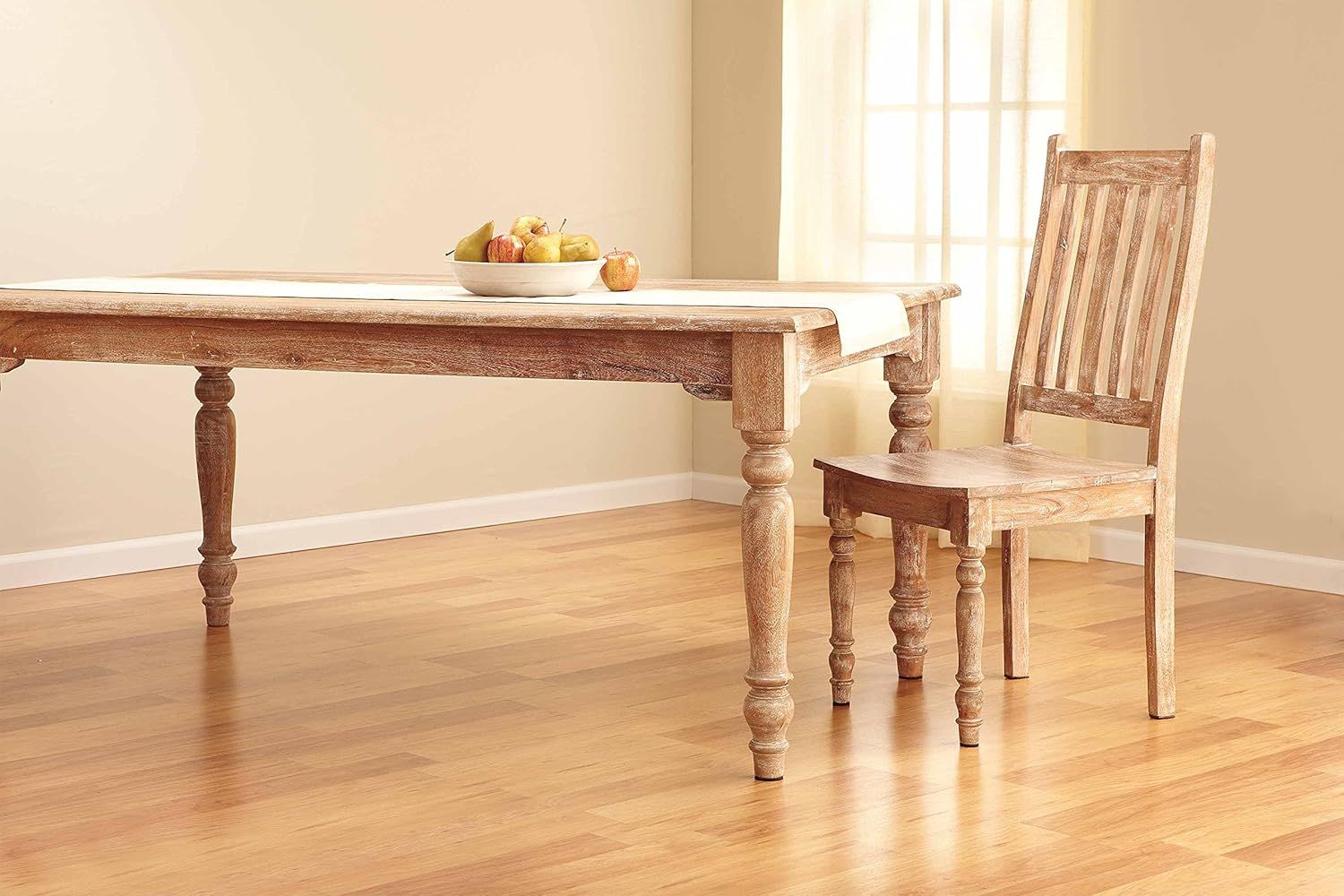 Showcases the product in a real-world home environment to help shoppers visualize how the furniture would look in their own dining space.