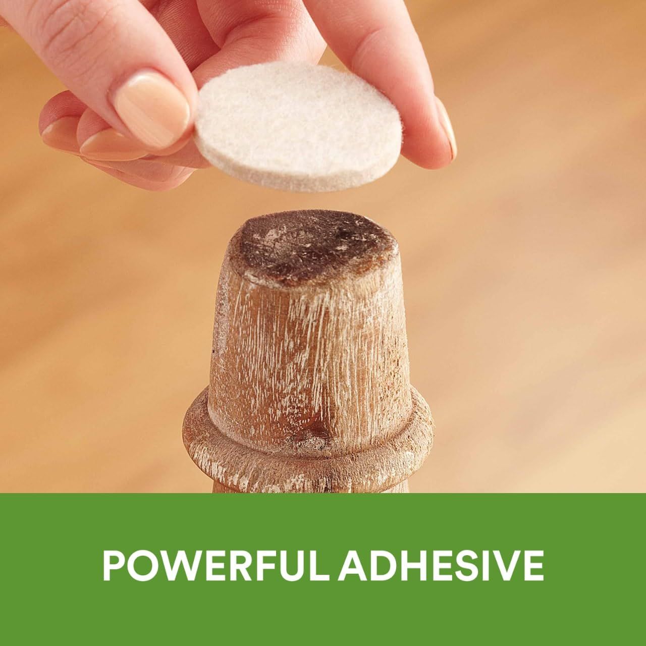 Demonstrates the product's strong adhesive capability by showing a hand holding a pad above a wooden surface, reassuring shoppers that the product will stick securely.