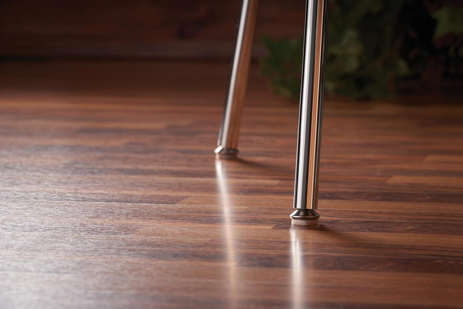 Shows the product in a real-world home setting on hardwood flooring to help shoppers visualize how it looks in their space and demonstrate its floor-friendly design.
