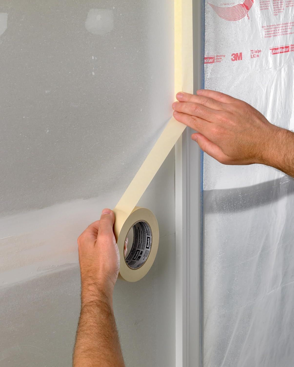 Demonstrates how to properly apply masking tape to protect surfaces during painting or renovation work, showing the ease of use and proper technique.