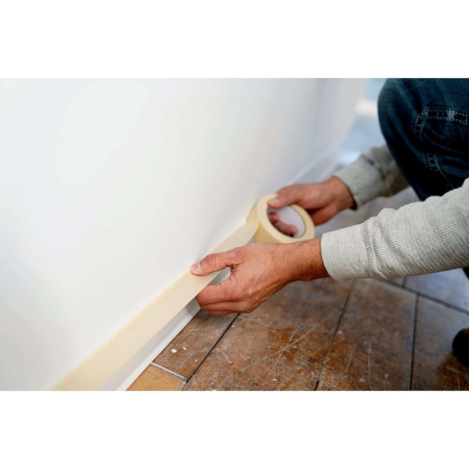 Demonstrates how to apply the product (tape or adhesive strip) along baseboards or trim, showing shoppers the ease of installation or use. Communicates the simplicity and ease of applying the…