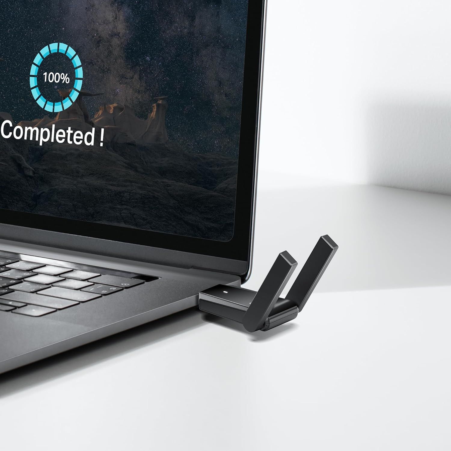 Demonstrates the product (WiFi adapter) in a real-world setting connected to a laptop, showing how it integrates seamlessly into everyday computing use.
