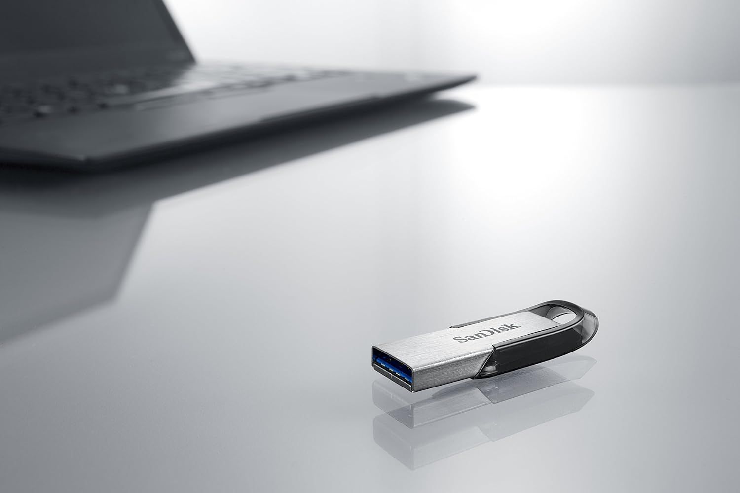 Demonstrates the product in a real-world office or workspace setting to help shoppers visualize the USB drive in their daily professional context.