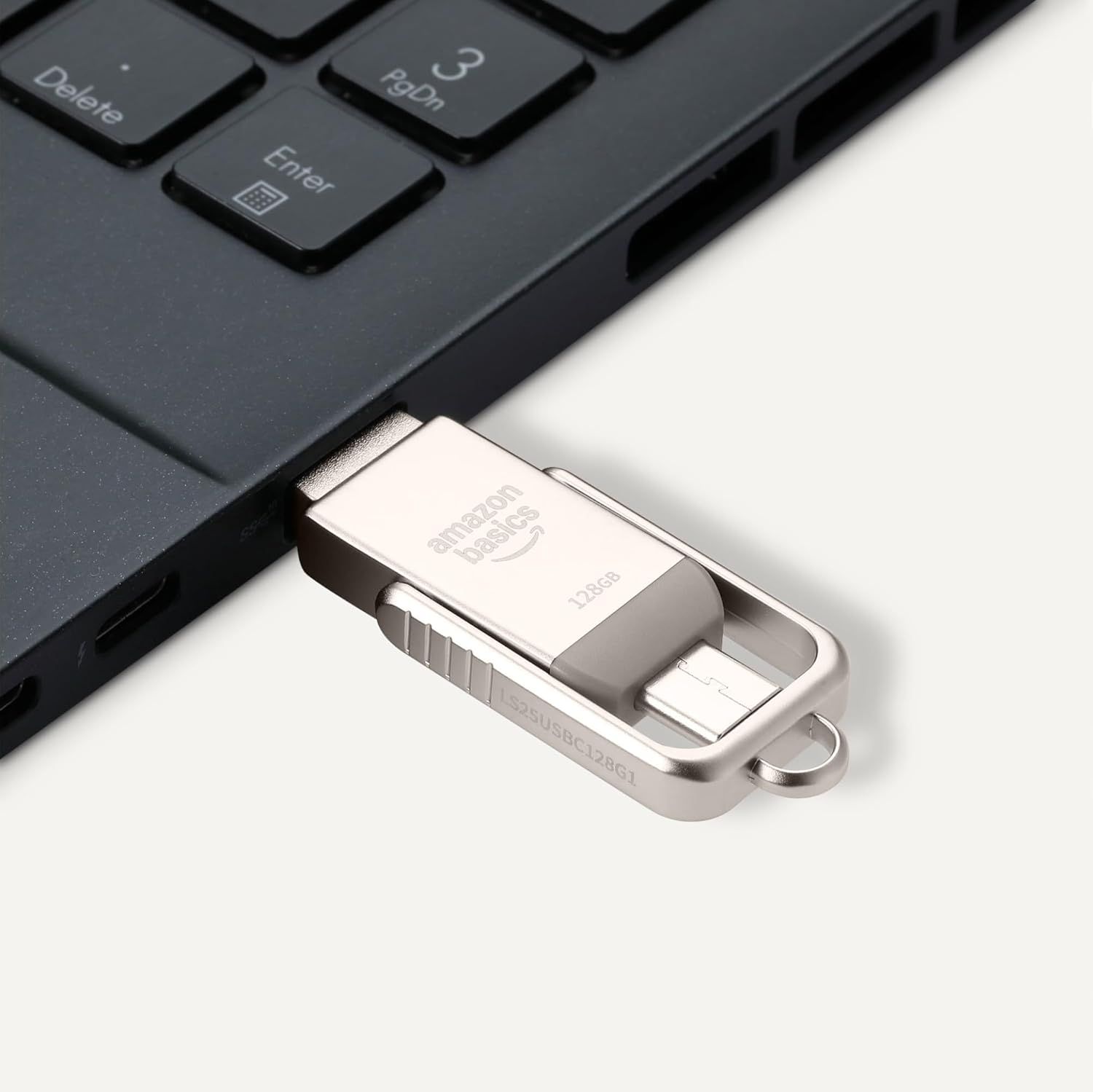 Provides a clean, catalog-style product view showing the dual-connector flash drive design and its compatibility with laptops, emphasizing the physical product and its connection capability.