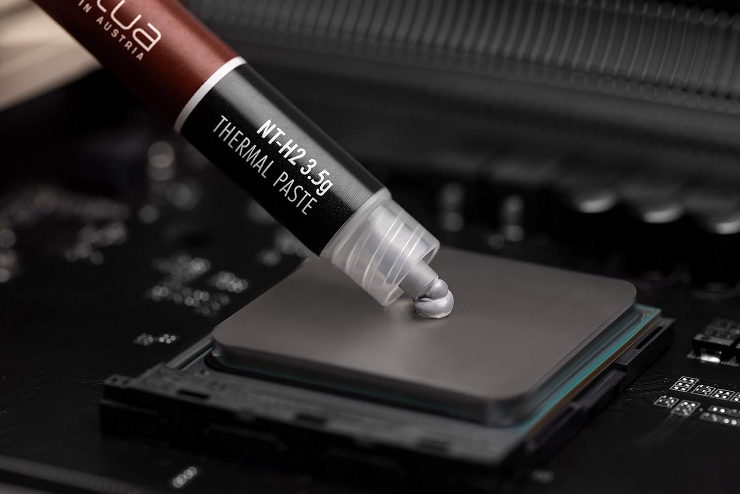 Demonstrates the product being applied to a CPU, showing shoppers the practical use case and professional quality of the thermal paste for computer cooling.
