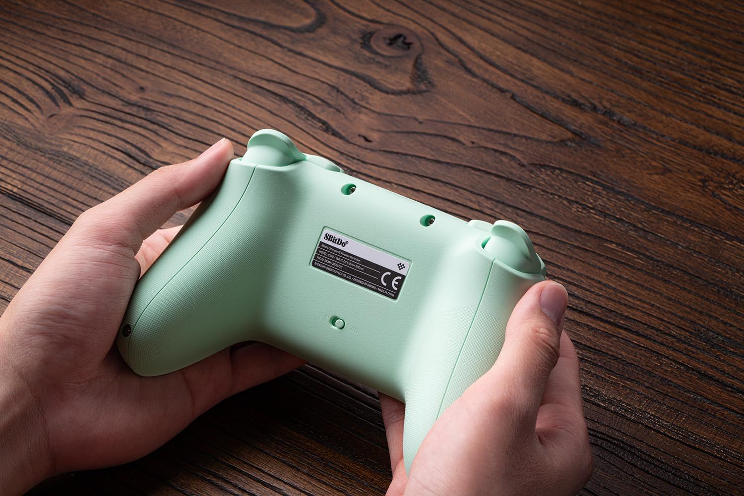 Demonstrates the product being held and used in a real-world setting to help shoppers visualize the gaming controller in their hands and understand its ergonomic design.