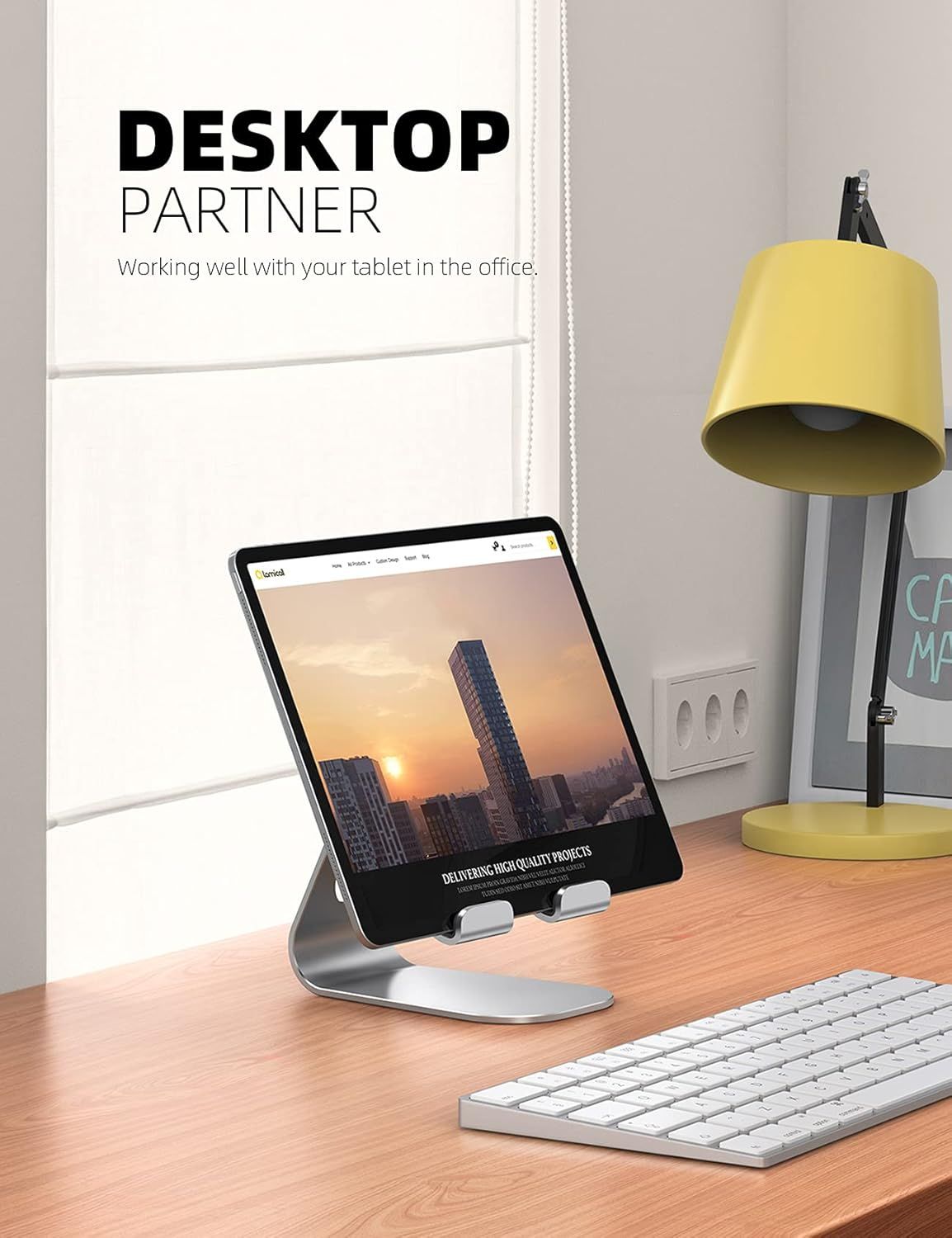 Demonstrates the product in a real-world office environment to help shoppers visualize how the tablet stand fits into their workspace.