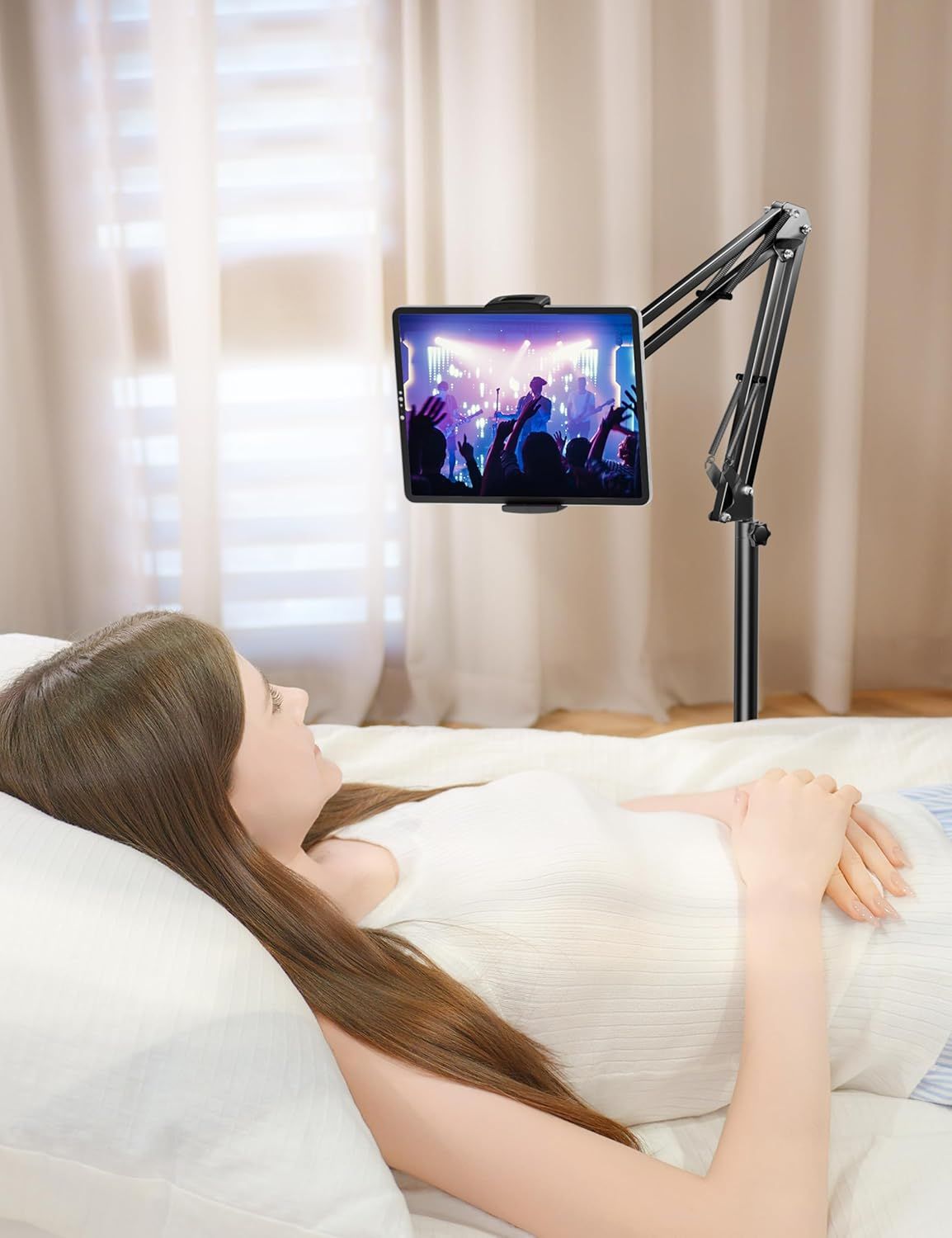 Demonstrates the product in a real-world bedroom setting to show how the tablet holder enables comfortable, hands-free viewing while lying in bed.