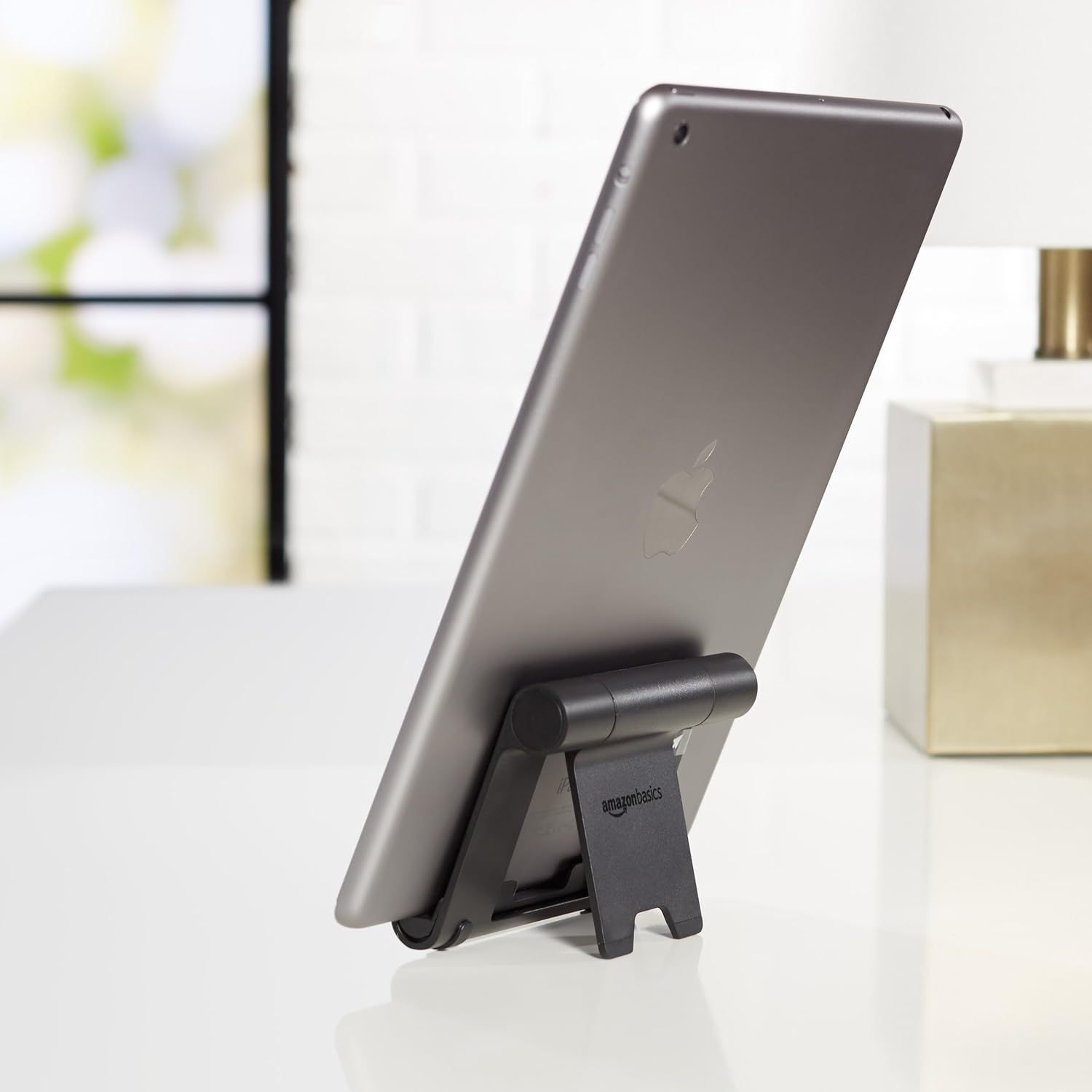 Demonstrates the product in a real-world setting, showing how the stand holds a tablet at a comfortable viewing angle on a desk or table.
