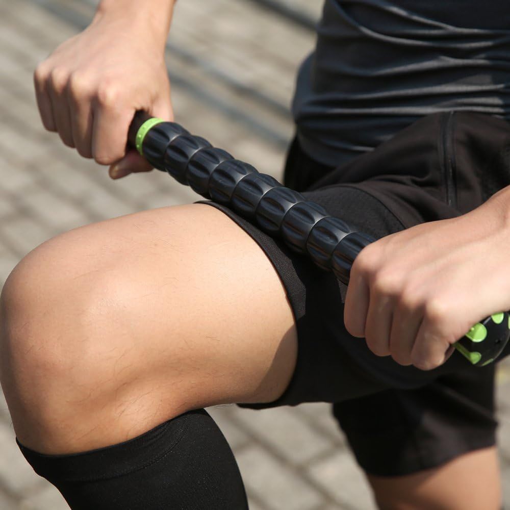 Demonstrates the product in a real-world fitness context, showing how the massage roller is used on the leg to communicate its practical application for muscle recovery and post-workout care.