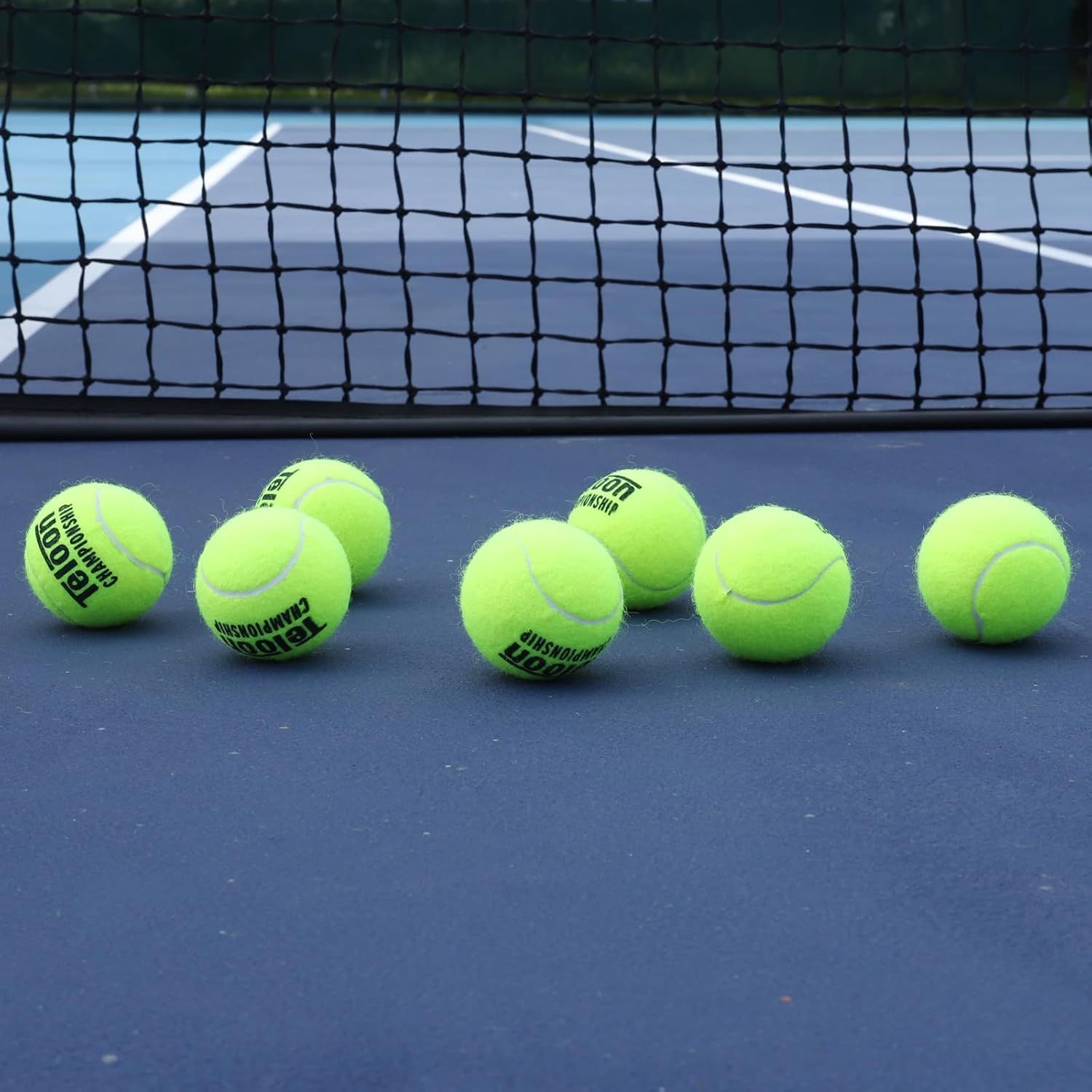 Shows the tennis balls in their natural use environment on a tennis court to help shoppers visualize the product in real-world play conditions.