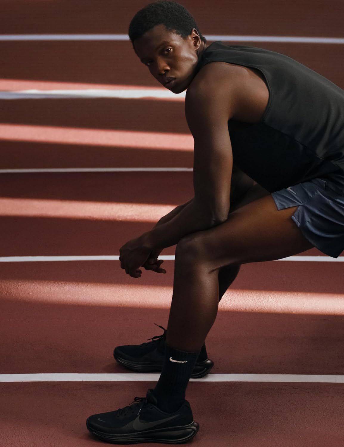 Showcases the product in an authentic athletic environment to create an aspirational lifestyle connection and demonstrate real-world use on a running track.