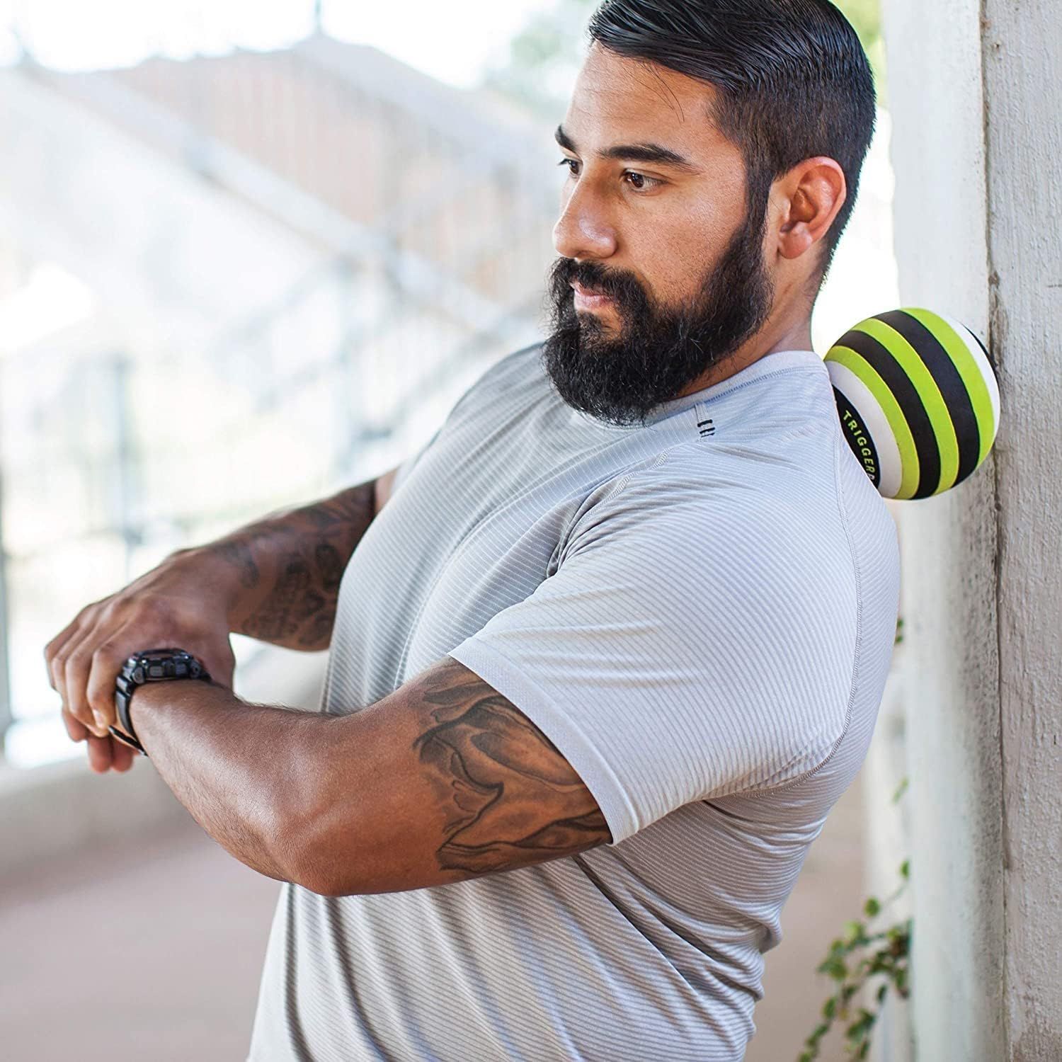 Demonstrates the product being used in a real-world outdoor setting to help shoppers visualize how the massage ball fits into an active lifestyle and recovery routine.