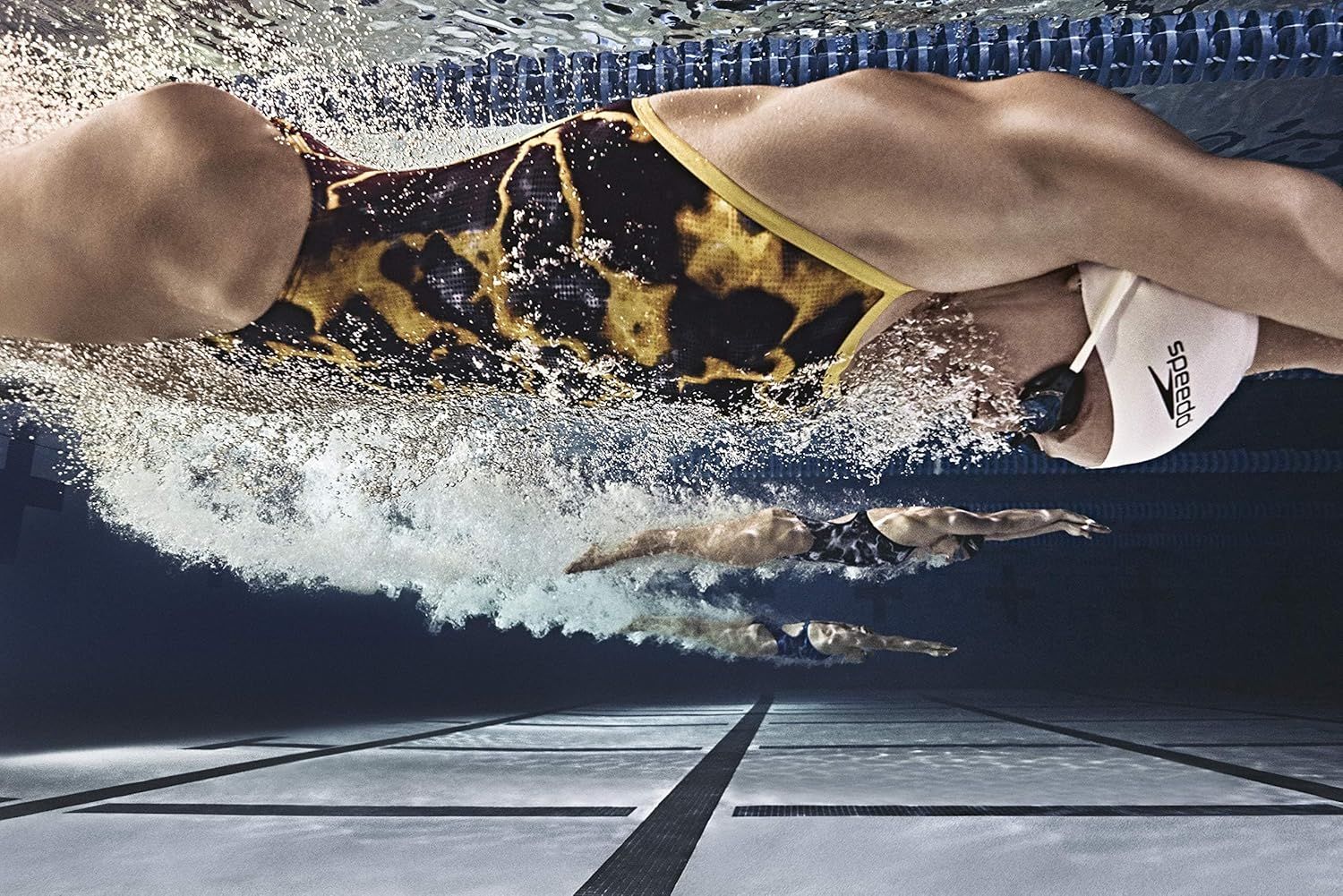 Demonstrates the product in use during competitive swimming to show its real-world application and performance in an athletic context.