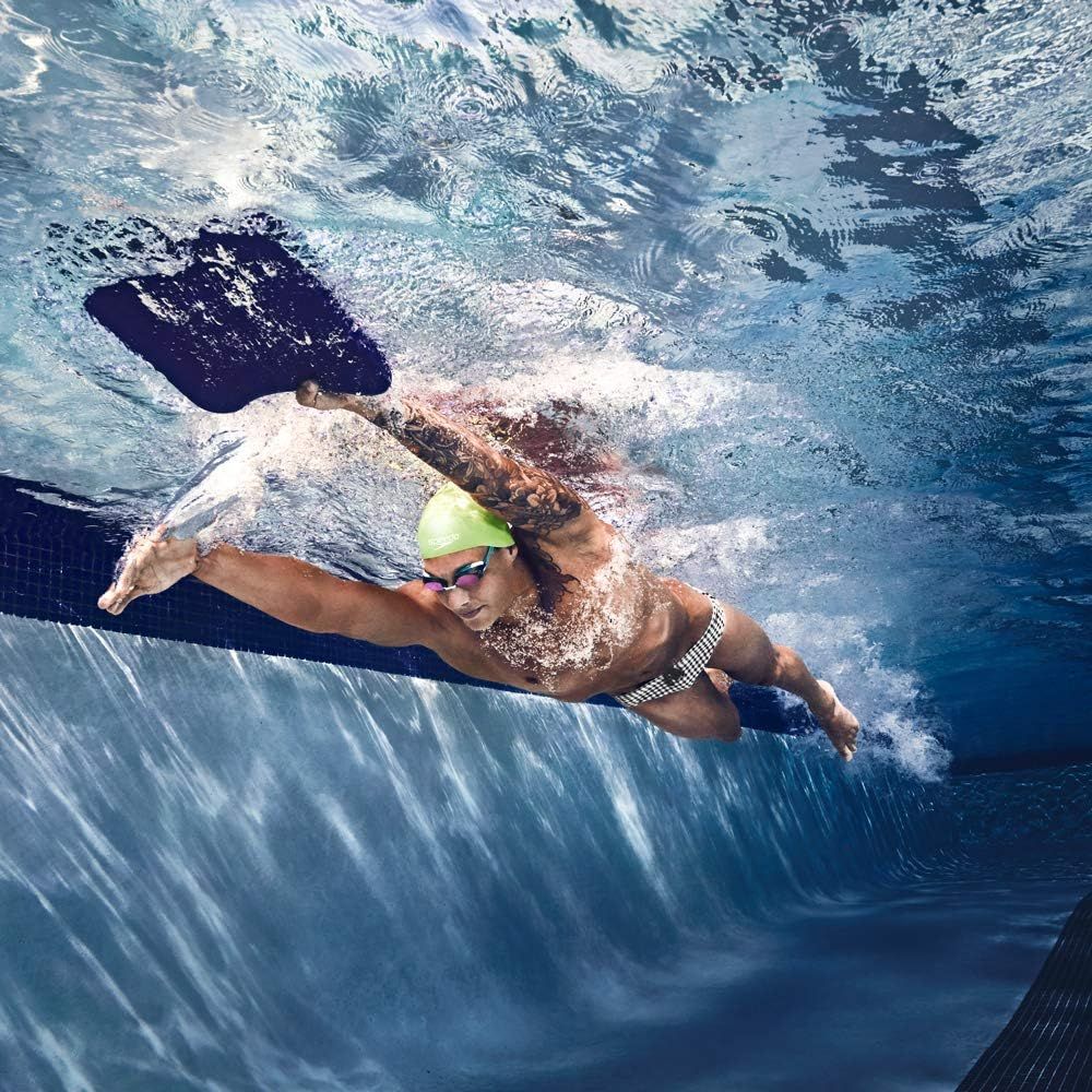 Shows the product (swim goggles and swim cap) in real-world use during swimming, helping shoppers visualize the product in action.