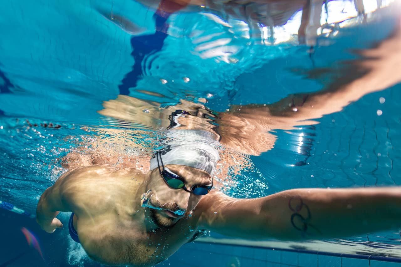 Shows the product (swim goggles) in real-world use during swimming to help shoppers visualize the product in action.