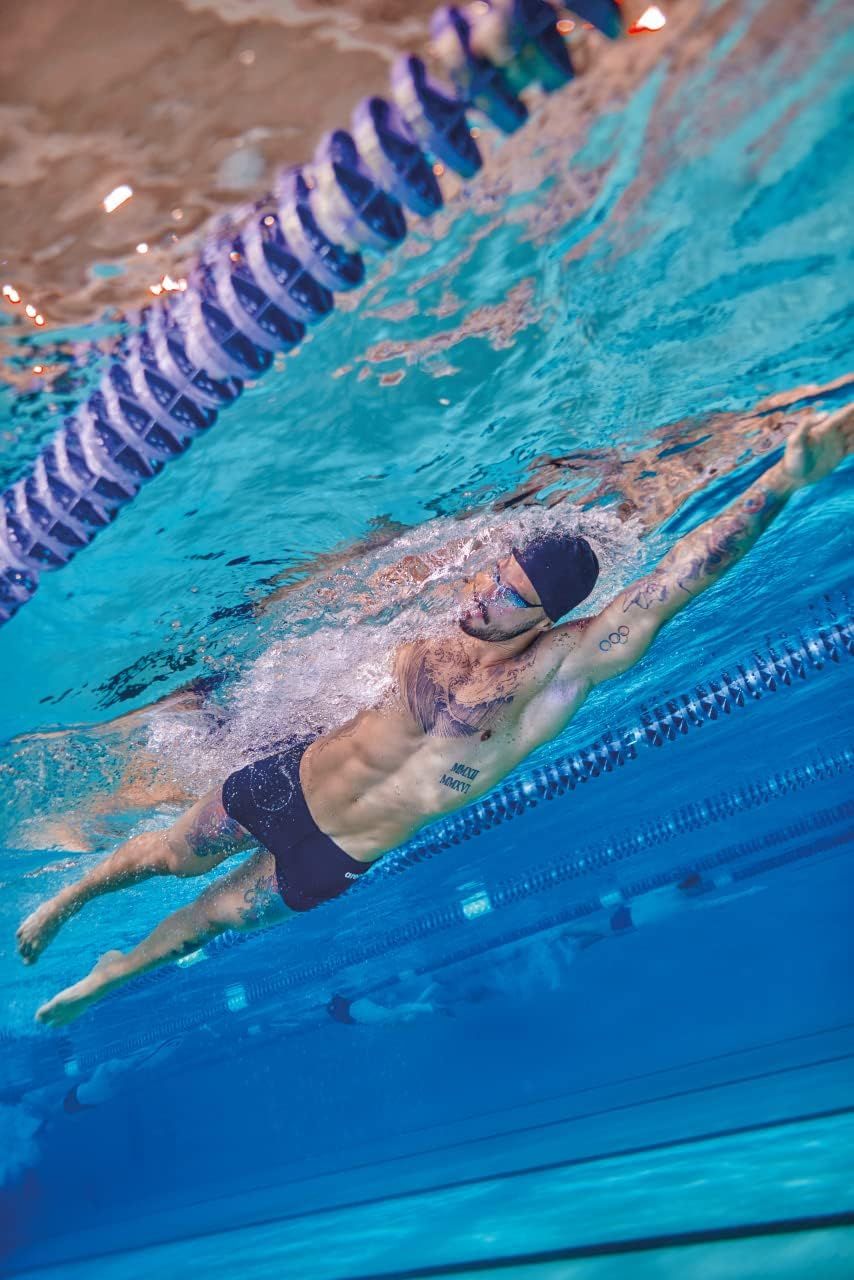Shows the product being used in a real swimming pool environment to help shoppers visualize the product in authentic athletic use.