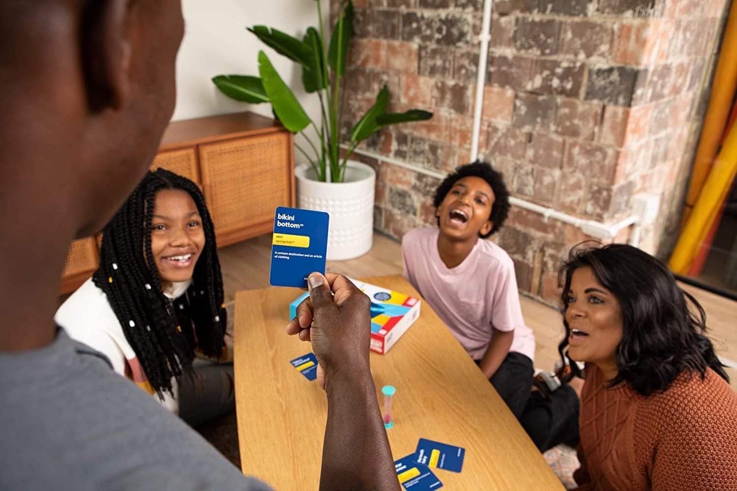 Shows the product being enjoyed in a real-world social setting with friends or family, creating an emotional connection and demonstrating the product's role in bringing people together.