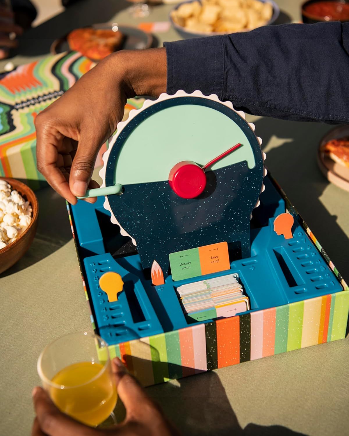 Demonstrates the product being used in a natural, social environment to help shoppers visualize how it fits into everyday life and entertainment scenarios.