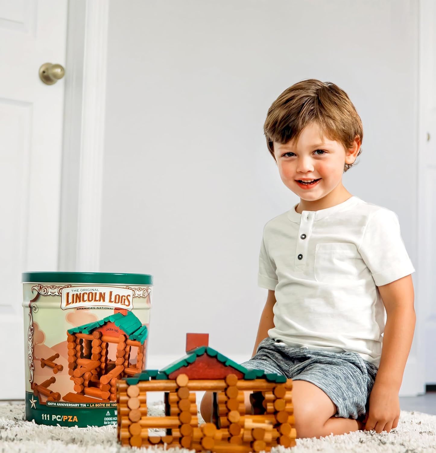 Shows the product in a real-world home setting with a happy child to demonstrate the play experience and appeal to parents looking for engaging toys for their kids.