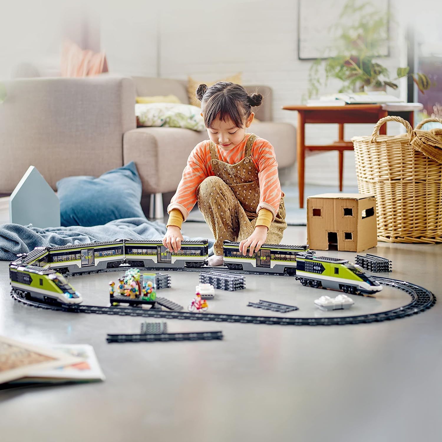 Demonstrates the product in a real-world home setting to show how children engage with and enjoy the toy train set, creating an emotional connection with potential buyers.
