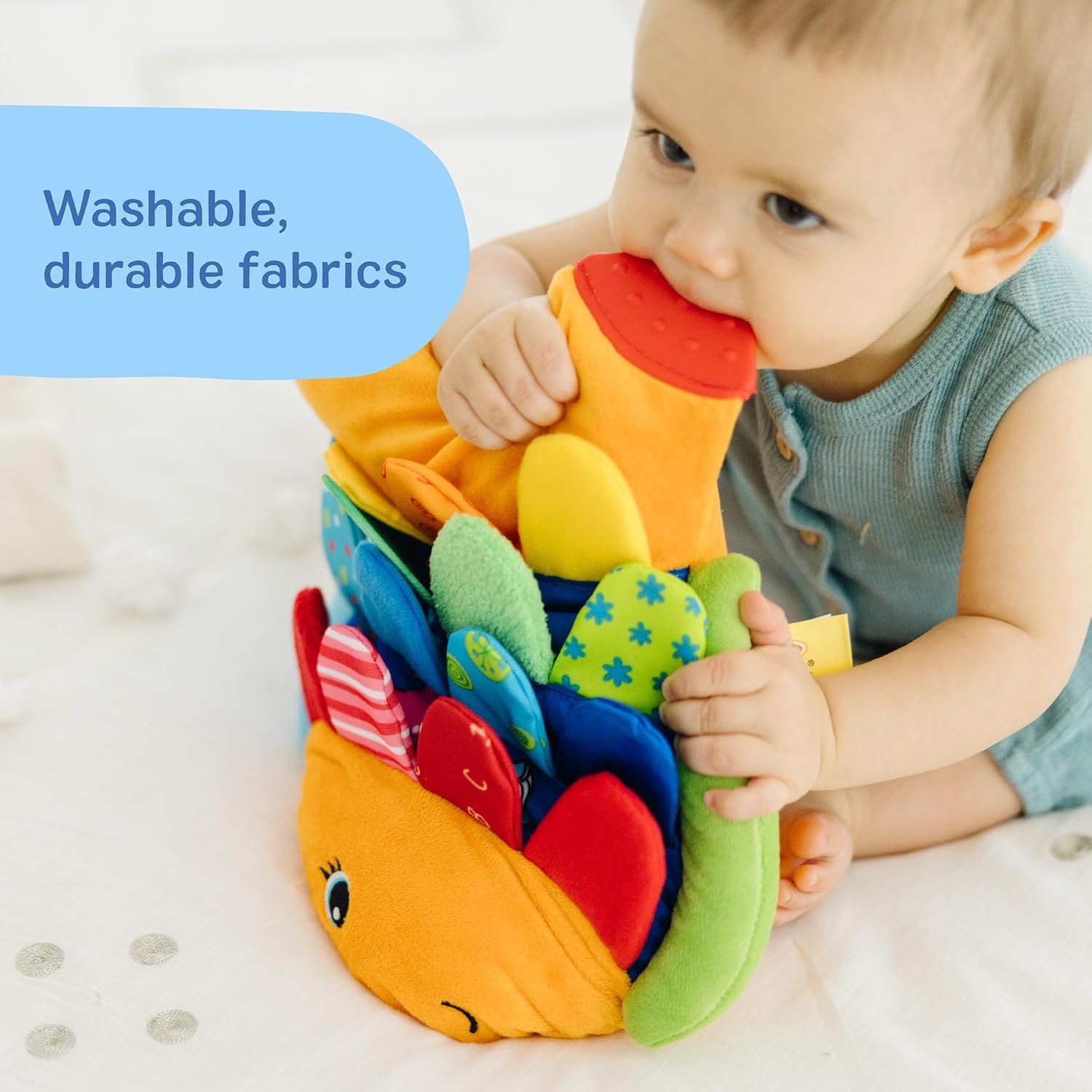 Reassures parents that the toy is made from washable and durable fabrics, making it practical for babies and easy to maintain.