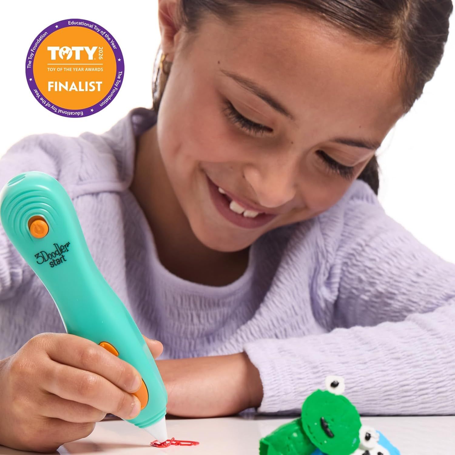 Communicates third-party credibility and recognition by displaying the Toy of the Year Awards Finalist badge, reassuring shoppers of the product's quality and industry validation. Shows a child…