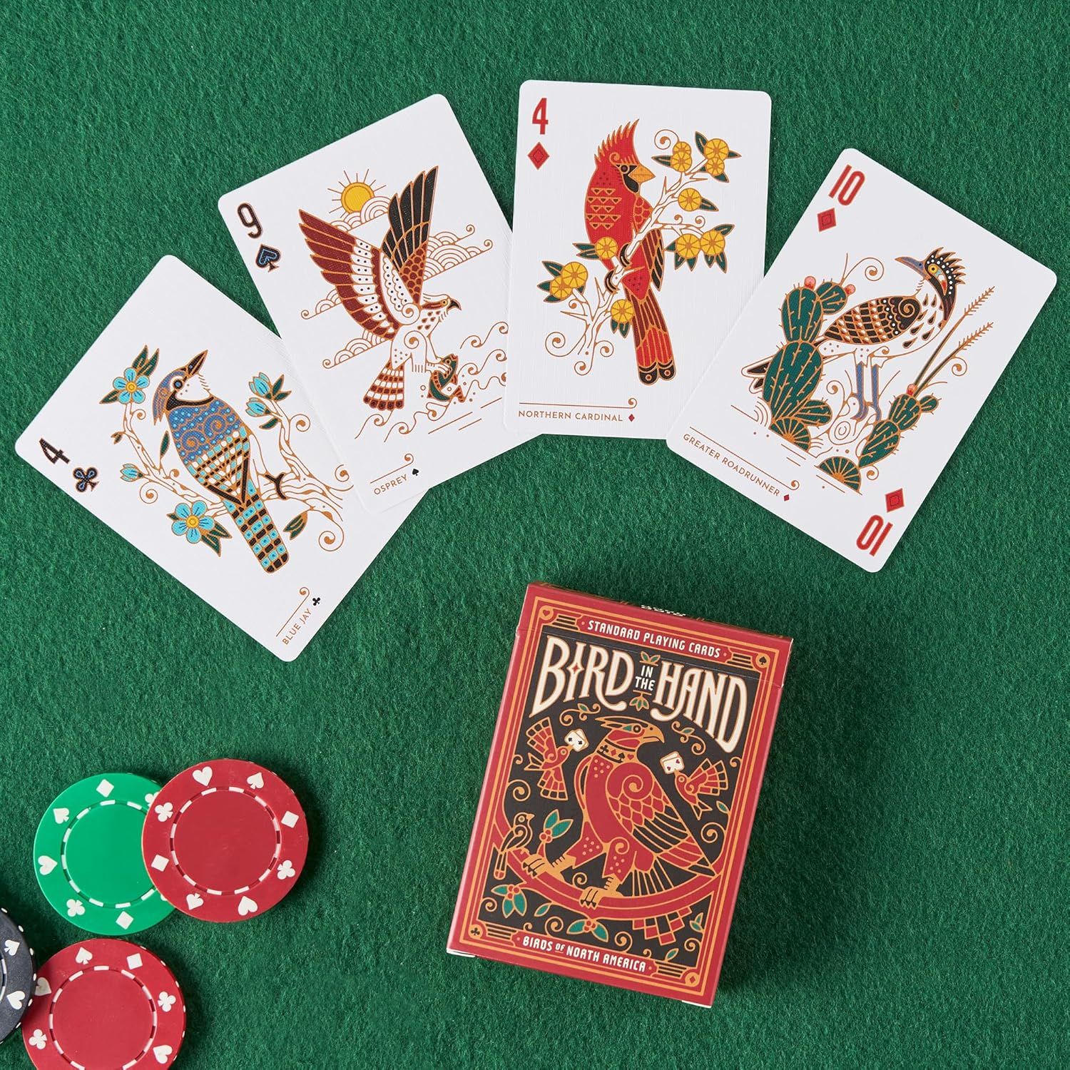 Shows the playing cards and packaging in a clean, lifestyle setting to help shoppers visualize the product design and artistic style of the Bird in the Band deck.