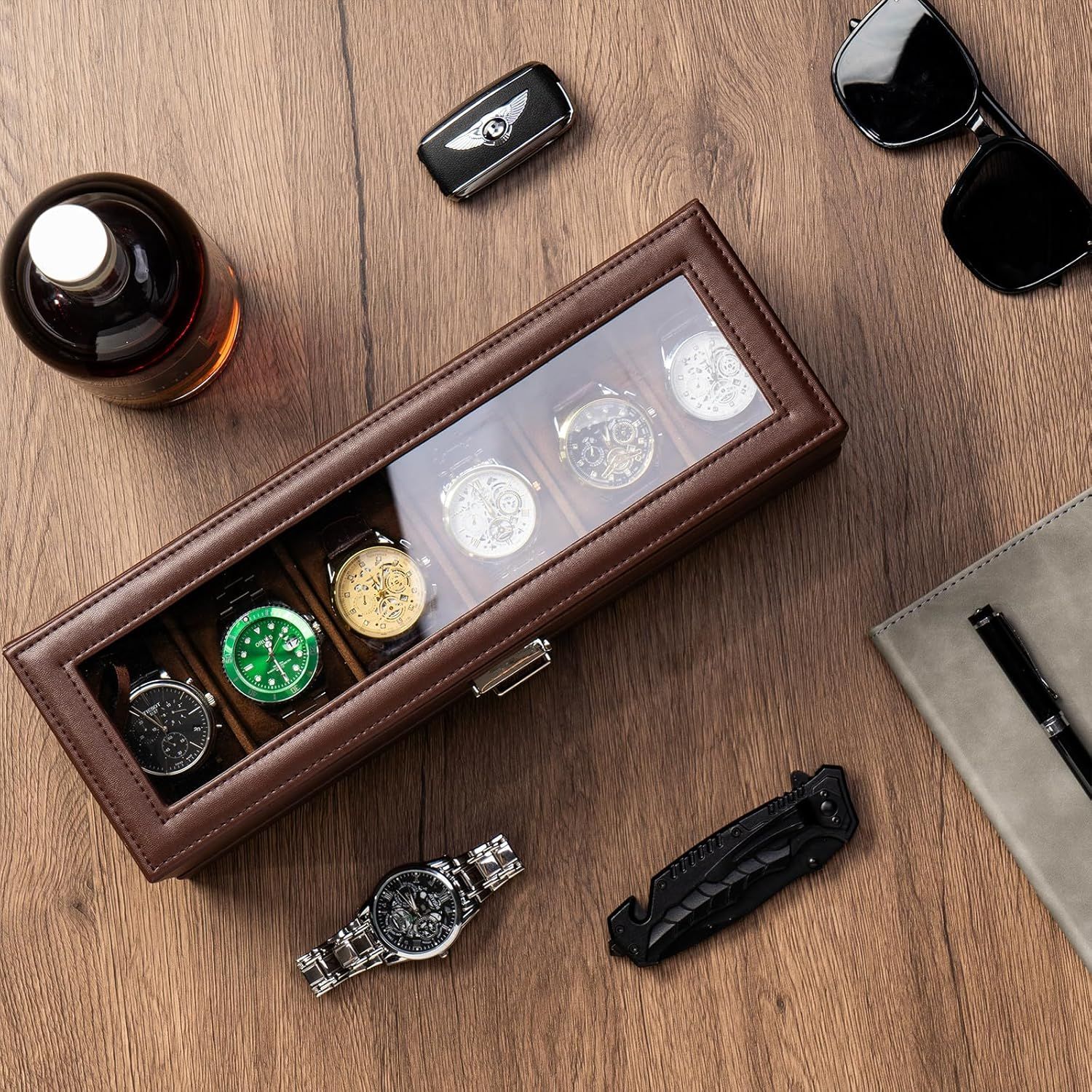 Showcases the watch storage case in an aspirational lifestyle setting with complementary luxury accessories to communicate sophistication and appeal to style-conscious shoppers.